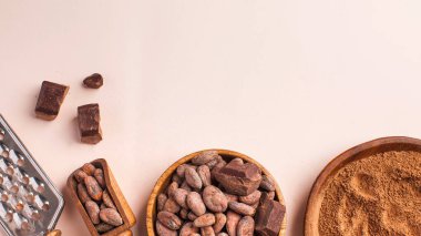 Cocoa beans, cocoa powder, raw chocolate on a pink background. The concept of healthy eating. High quality photo clipart