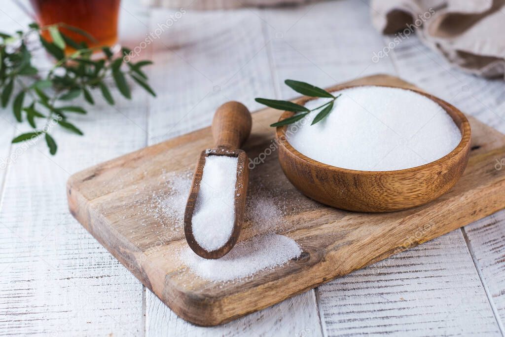 Natural sweetener in a wooden spoon. Sugar substitute. Erythritol