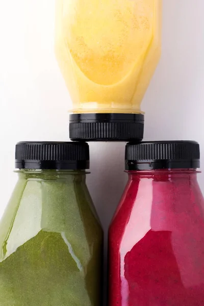 Fruit and vegetable smoothies in bottles close-up. Place for the logo.