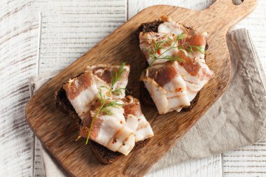 Ukrayna domuzu, domuz yağı, ahşap bir tahtanın üzerine taze kesilmiş otlar serpiştirilmiş. Boşluğu kopyala.