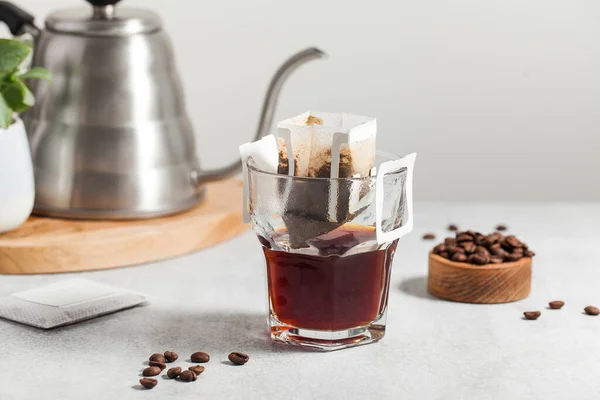 Drip coffee bag in a mug. Trends in brewing coffee at home.