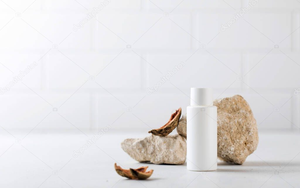 A white tube with an organic cosmetic care product surrounded by natural materials. The concept of eco cosmetics. 