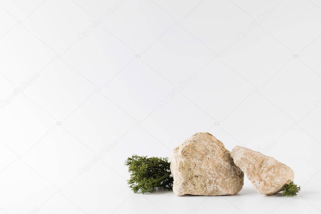 A podium made of gray stones, moss for the presentation of your product. Modern display of goods