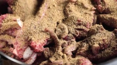 Şef et için kuru baharatlarla domuz etini marine ediyor..