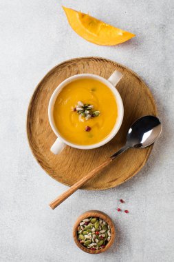 Gri arkaplanlı kabak kremalı çorba. Rahat sürüş, sonbahar menüsü. 