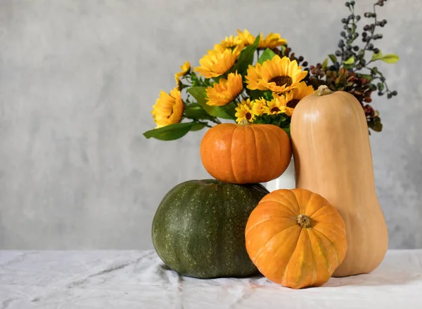 Herbstliche Komposition aus Kürbissen und einem Strauß Sonnenblumen. Kopierraum. — Stockfoto