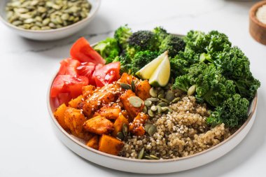 Besleyici bir yemek için kinoalı, balkabaklı ve sebzeli sağlıklı vegan Buda kasesi. Sebze tarifleri kavramı.