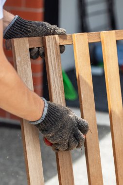 Zımpara kağıdıyla ahşap bir mobilyayı zımparalayan bir zanaatkarın yakın çekimi. Mobilya restorasyonu, ahşap işçiliği, DIY ev geliştirme, el işçiliği ve geleneksel işçilik kavramı. Hazır.