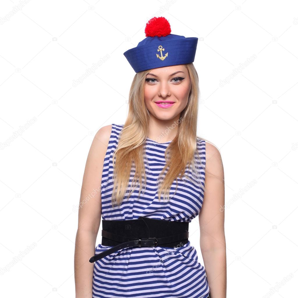 Young blond female sailor posing in her uniform and looking at the camera isolated on white background