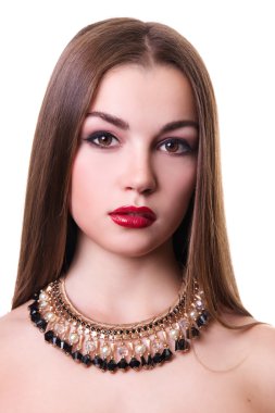 Closeup portrait of a beautiful girl with a black and gold necklace around her neck. Isolated over white background.