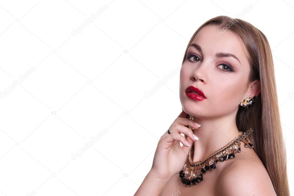 Closeup portrait of a beautiful girl with a black and gold necklace around her neck. Isolated over white background. Copy space.