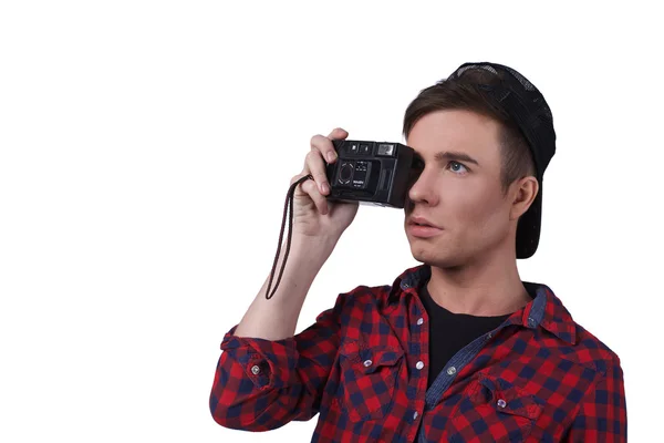 Portrait of a young attractive man with a camera in hand isolated on white background . copy space — Stock Photo, Image