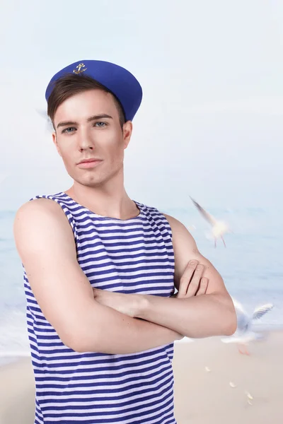 Young handsome sailor in the background of the sea — Stock Photo, Image