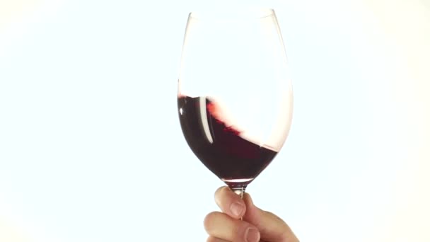 Bewegende rode wijnglas, wit, slowmotion — Stockvideo