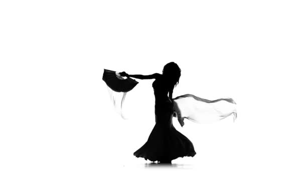 Schlanke exotische Bauchtänzerin Frau tanzt weiter, verwendet Fächer, auf Weiß, Zeitlupe, Silhouette — Stockvideo