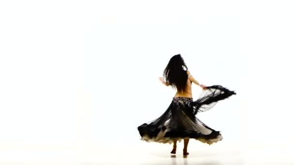 Beautiful young exotic belly dancer with long dark hair in unusual suit dancing, on white — Stock Video