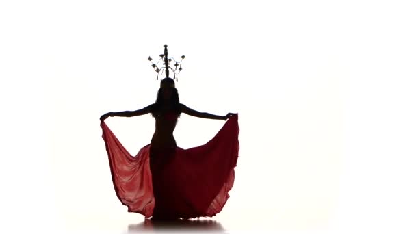 Attractive belly dancer girl dancing with candles on her head, silhouette, on white — Stock Video