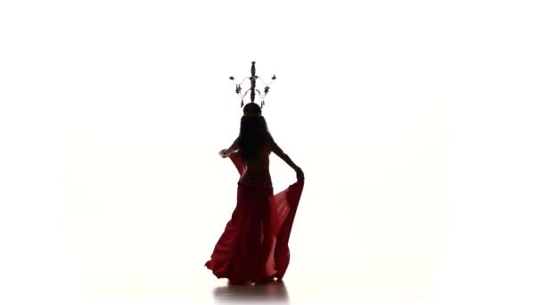 Attractive belly dancer woman dancing with candles on her head, silhouette, on white — Stock Video