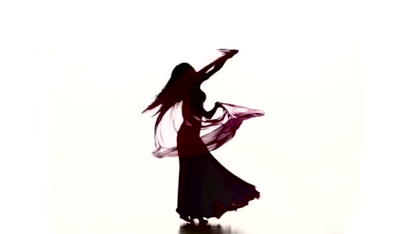 Pretty young woman continue dancing belly dance with colored shawl, on white, slow motion — Stock Video