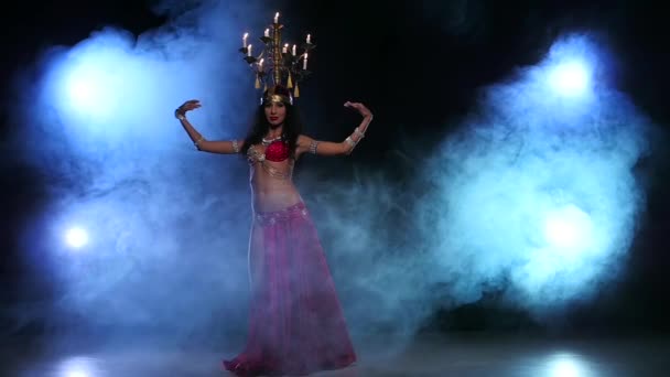 Attractive belly dancer starts dancing with candles on her head, black, smoke, slow motion — Stock Video