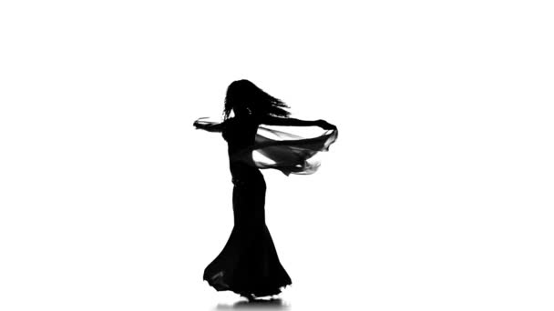 Pretty young girl dancing belly dance with shawl, sihouette, white, slow motion — Wideo stockowe