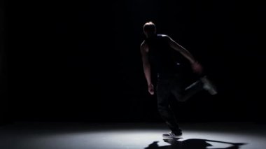 Young handsome dancer man dancing breakdance on black