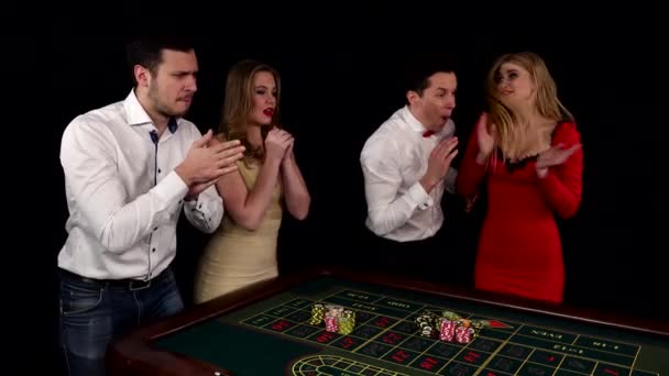 Company of young people playing roulette. Black — Stock Video