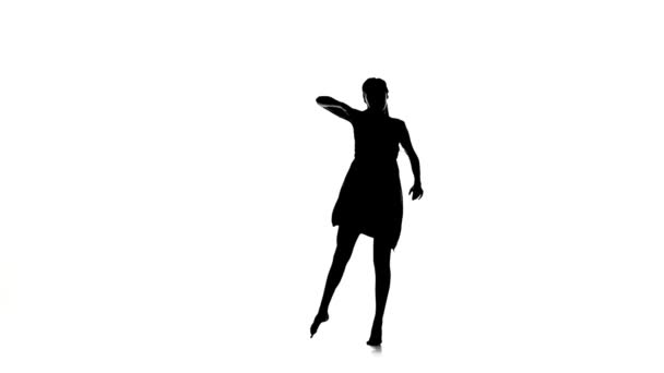 Young woman dancer goes on dancing contemporary dance on white, silhouette, slow motion — Stock Video