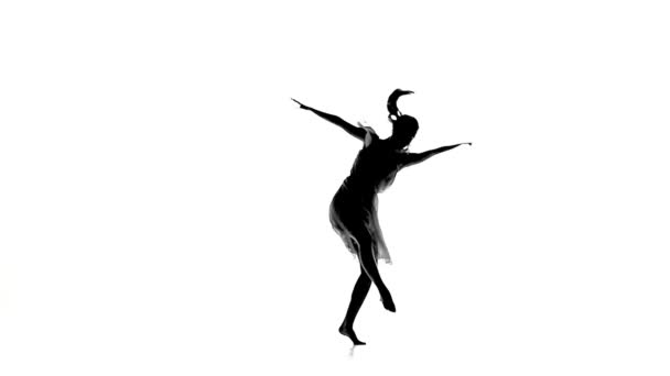 Chica delgada con cola de caballo danza moderna de estilo contemporáneo gira en blanco, silueta, cámara lenta — Vídeos de Stock