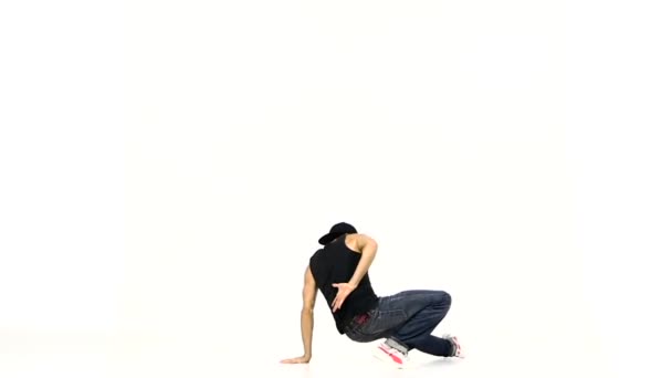 Modern style dancer in black suit starts dancing breakdance on white, slow motion — Stock Video
