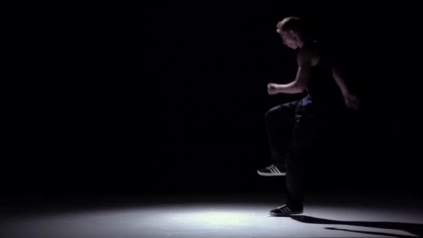 Dancer jumps over his head, dancing breakdance, on black, shadow, slow motion — Stock Video