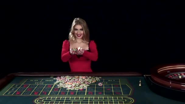Winning woman tossing up chips. Black. Slow motion — Stock video