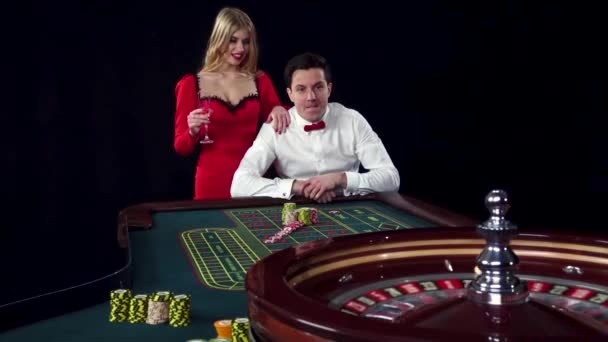 Couple playing roulette wins at the casino. Black — Stock Video