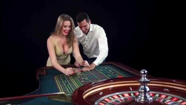 Young couple celebrating win in casino. Black — Αρχείο Βίντεο