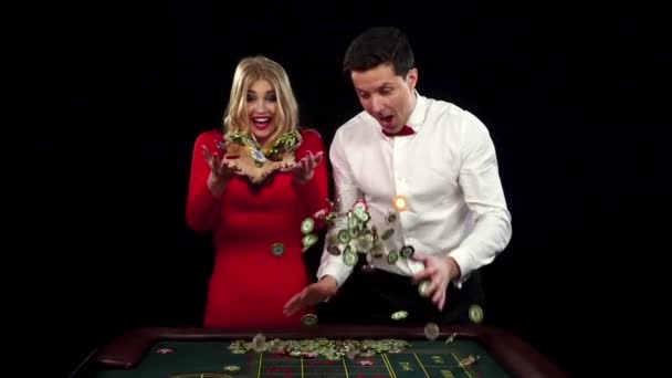 Cute couple winning and throwing chips in the air. Black — Stock Video