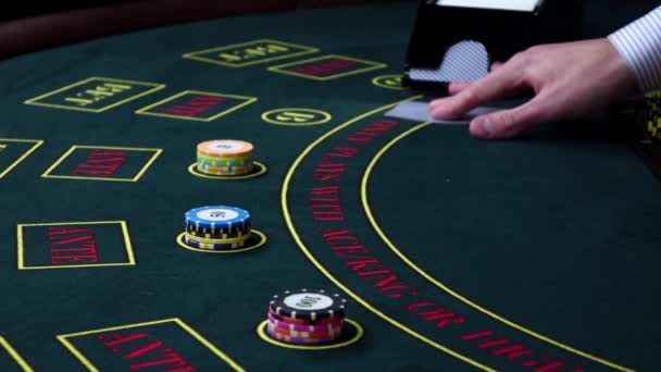 Croupier deal cards on green table with chips, slow motion — Stock Video