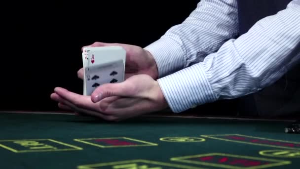 Croupie shuffling the standart poker cards, on black, slow motion — Stock Video