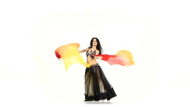 Belly dancer brunette woman in unusual costume dance with long fans, on white, slow motion — Stock Video