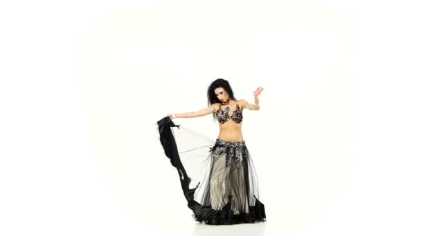 Beautiful belly dancer dark hair, shaking her hips and whirl, on white, slow motion — Stock Video
