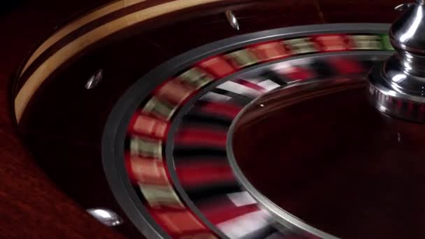 One part of fast running wheel roulette, white ball falls on 22, close up — Stock Video