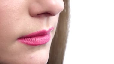 Woman biting her beautiful lips. Closeup