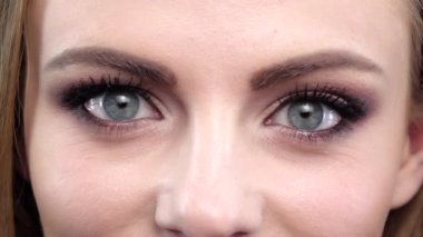 Womans eye, squint. Close up. Slow motion