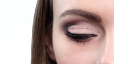 Woman eye with bright makeup. Close up. Slow motion