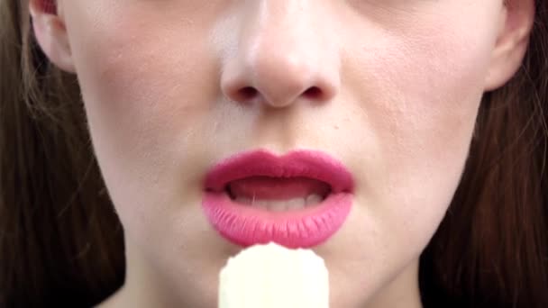 Female mouth eating peeled banana. Close up. Slow motion — Stock Video