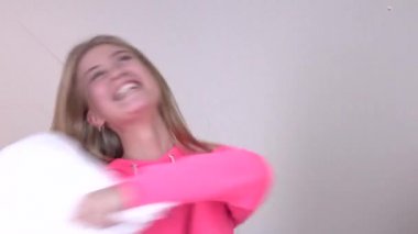 Young couple having a pillow fight, closeup