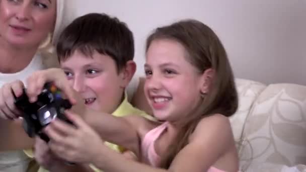 Loving siblings playing video game in the living room — Stock Video