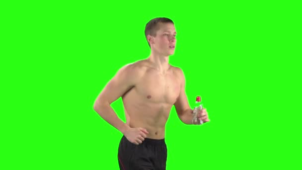 Athlete in shorts and a bottle of water during training. Green screen. Slow motion — Stock Video