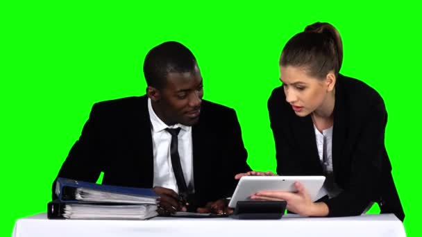 Business people examining a document in their office with a laptop — Αρχείο Βίντεο