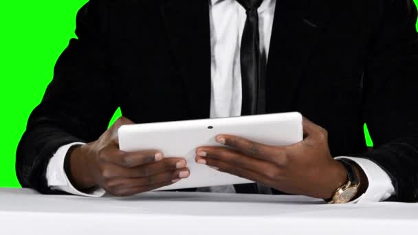 Бизнесмен сидит за столом и пользуется ноутбуком. Зеленый экран — стоковое видео