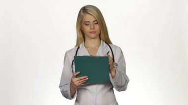 Health worker takes notes on clipboard. White